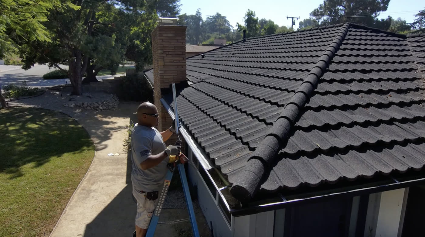 An Allied crew member completing roofline work that becomes part of the property record