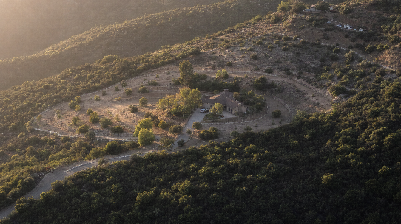 Aerial view of a residence ringed by bands of decreasing vegetation density